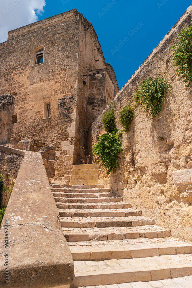 View of an old Italian house with a massive stone staircase. Streets of the city of Matera. The region of Basilicata, in Southern Italy.