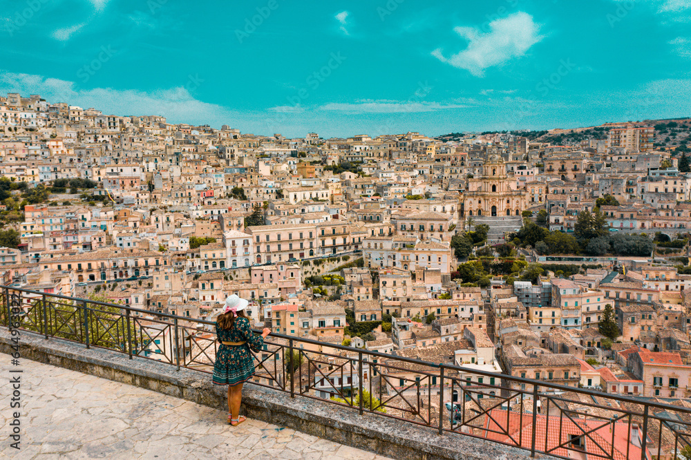Woman in aerial view of the old baroque town of Modica, Sicily, Italy. Ancient city.