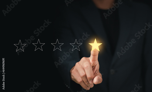 Customers rate service of Businessmen choose to rate 5 stars using smart phone and give five star symbol. Excellent rating. User give rating, feedback, good business network score..