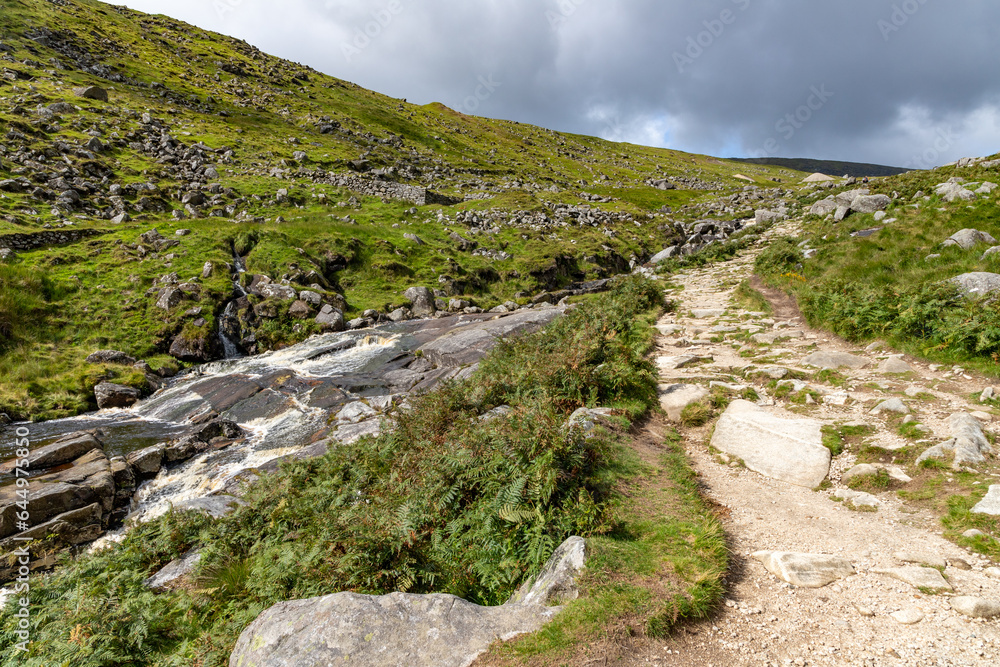 Trail with waterfall and rocks in Wicklow mountain