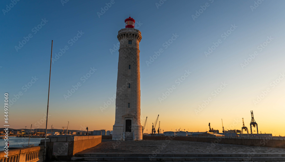 Lighthouse of Môle Saint Louis from the port of Sète, at sunrise, in Hérault, Occitanie, France Lighthouse of Môle Saint Louis from the port of Sète, at sunrise, in Hérault, Occitanie, France