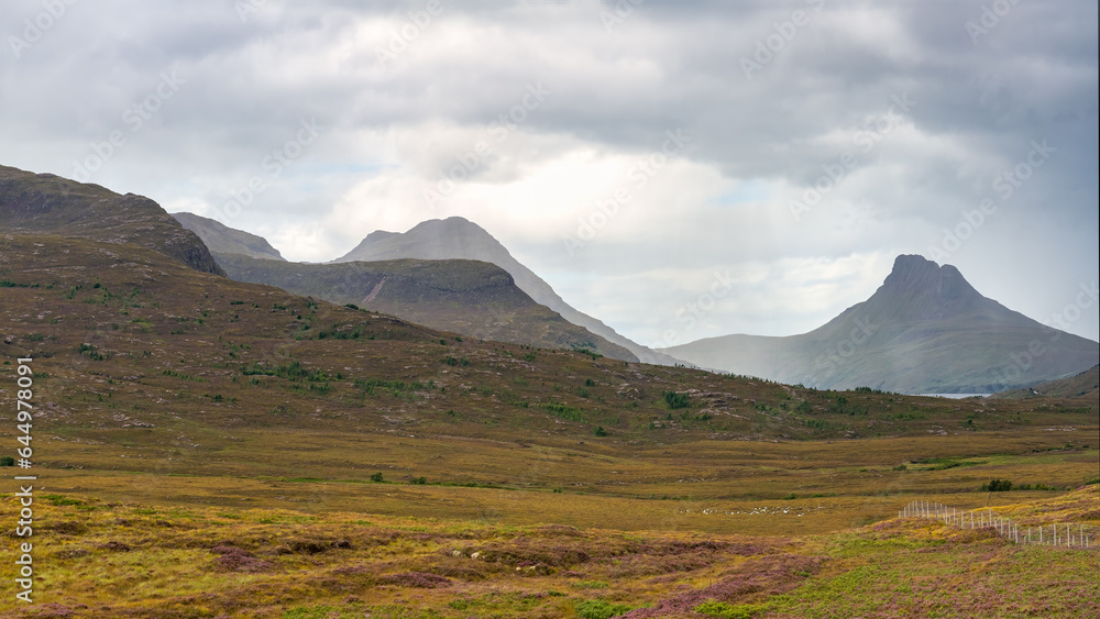 Ghostly mountain landscape with clouds and fog over the high peaks in the Highlands, Scotland. Ghostly mountain landscape with clouds and fog over the high peaks in the Highlands, Scotland.