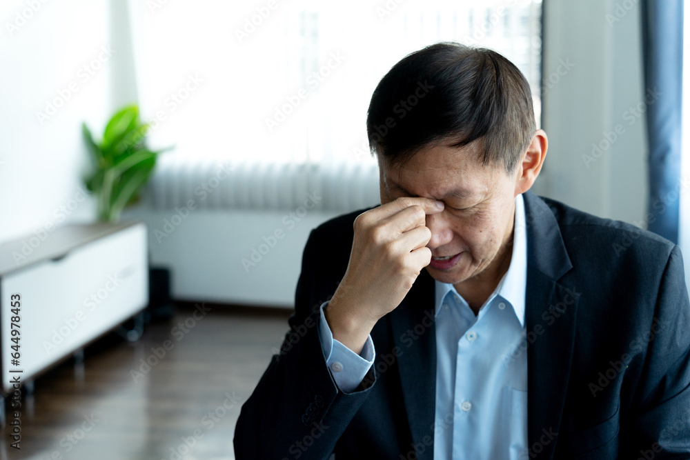 Lawyer or businessman is putting his hand between his eyes to relieve headaches Lawyer or businessman is putting his hand between his eyes to relieve headaches