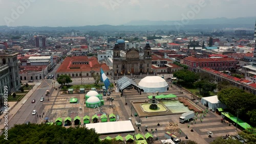 Capital centro de la ciudad de Guatemala vista por el cielo palacio municipal plaza central catedral de Guatemala arquidiócesis bandera guatemalteca ondeando color celeste photo