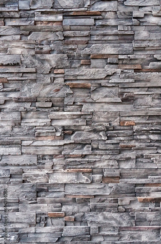 Empty brown and gray stone brick wall made with blocks for abstract background and texture. beautiful patterns, space for work, banner, wallpaper close up, vertical.