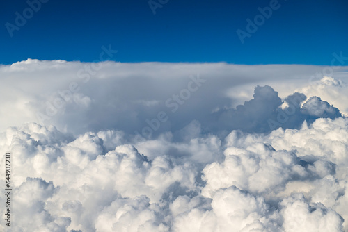 Beautiful Fluffy White and Gray Cumulonimbus Clouds on Blue Sky © Anna Hoychuk