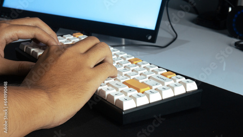 Someone typing on a white keyboard stock photo