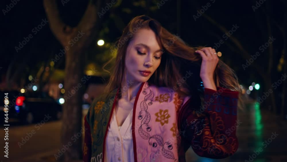 Gorgeous model walking night city near road close up. Woman strolling dark town Gorgeous model walking night city near road close up. Woman strolling dark town