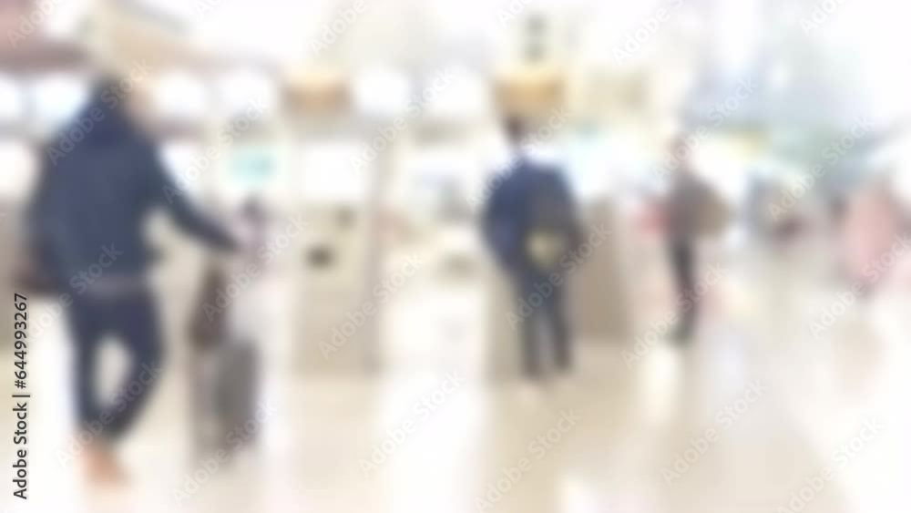 Blurred cinematic and slow motion shot of people using check-in machine at the airport terminal getting the boarding pass. Modern technology on airport. Blurred cinematic and slow motion shot of people using check-in machine at the airport terminal getting the boarding pass. Modern technology on airport.