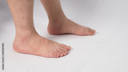 Fotografie Man legs and barefoot isolated on white background. side view