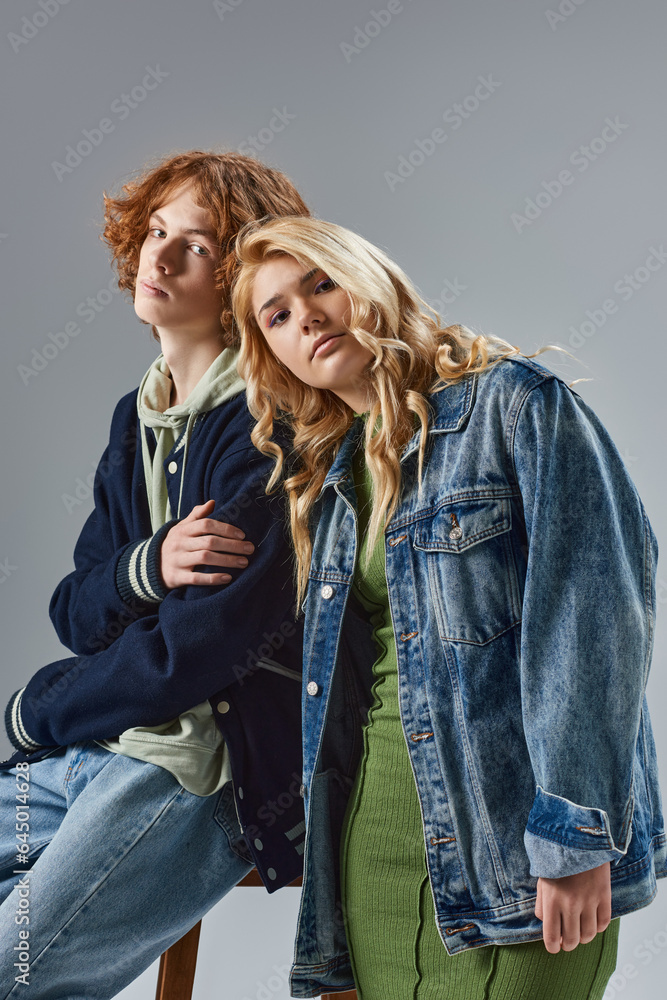 teenage friends in fashionable  casual attire posing and looking at camera on grey, youth fashion