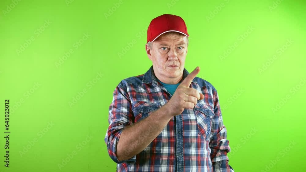 Old man in red baseball cap pointing at someone with finger and made inviting gesture. Old man in red baseball cap pointing at someone with finger and made inviting gesture.