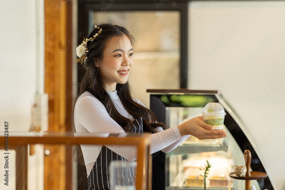 Stop by for homemade delicious bread! Portrait of asian young entrepreneur woman embracing work in her the bakery small business waiter standing in front of bakery shop. Stop by for homemade delicious bread! Portrait of asian young entrepreneur woman embracing work in her the bakery small business waiter standing in front of bakery shop.