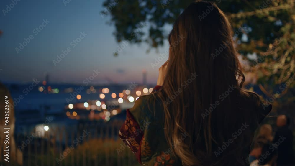 Woman filming night cityscape on smartphone standing observation deck close up. Woman filming night cityscape on smartphone standing observation deck close up.