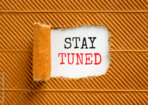 Stay tuned symbol. Concept words Stay tuned on beautiful white paper on a beautiful brown paper background. Business, support, motivation, psychological and stay tuned concept. Copy space.