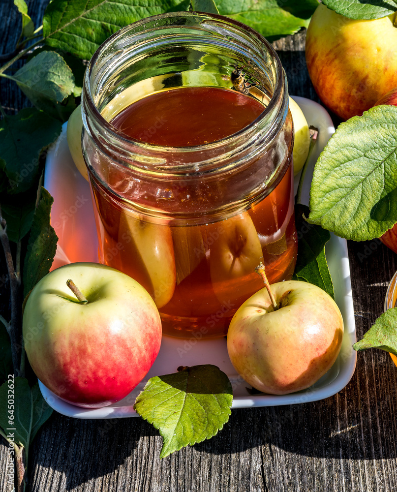 Close up with jar of honey and apples - main symbols of Jewish sweet New Year holiday - Rosh haShanah. Natural festive food attributes are on old textured wooden table Close up with jar of honey and apples - main symbols of Jewish sweet New Year holiday - Rosh haShanah. Natural festive food attributes are on old textured wooden table