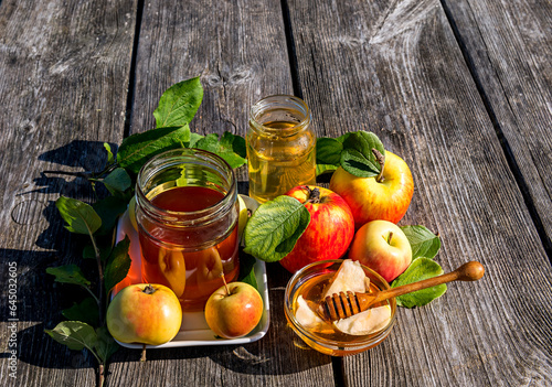 Close up with jars of festive honey and apples - main symbols of Jewish sweet...