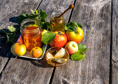 Close up with jars of sweet honey and apples - main symbols of Jewish sweet N...