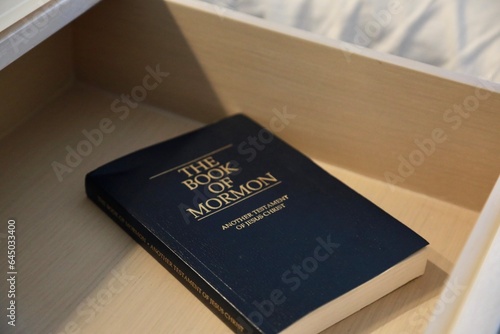 Hotel nightstand with Book of Mormon in drawer