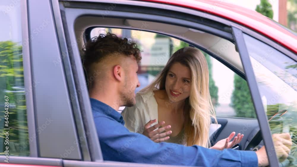 Smiling pretty lady sitting in the car while enjoying of talk with her boyfriend, having fun. Right hand drive car. Trip, vacation, love, relationship concept. Real time Smiling pretty lady sitting in the car while enjoying of talk with her boyfriend, having fun. Right hand drive car. Trip, vacation, love, relationship concept. Real time