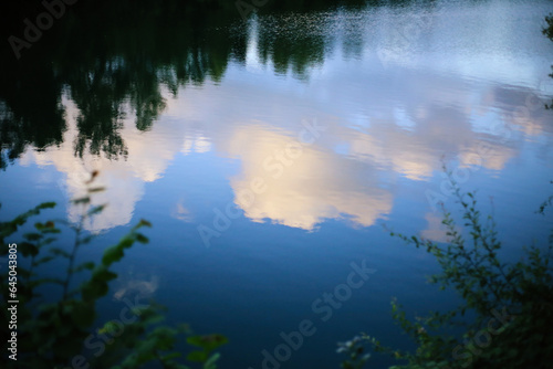 Reflection of clouds in the lake. Nature composition. Selective focus.