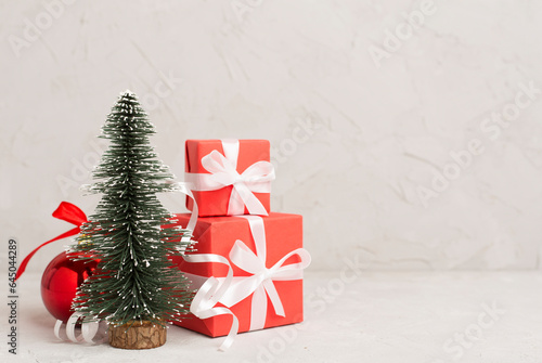 Miniature christmas tree with gift boxes and decor on table