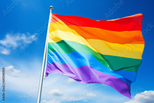 AI generative photography of bright colorful rainbow lgbtq+ flag isolated on blue sky background © Tetiana