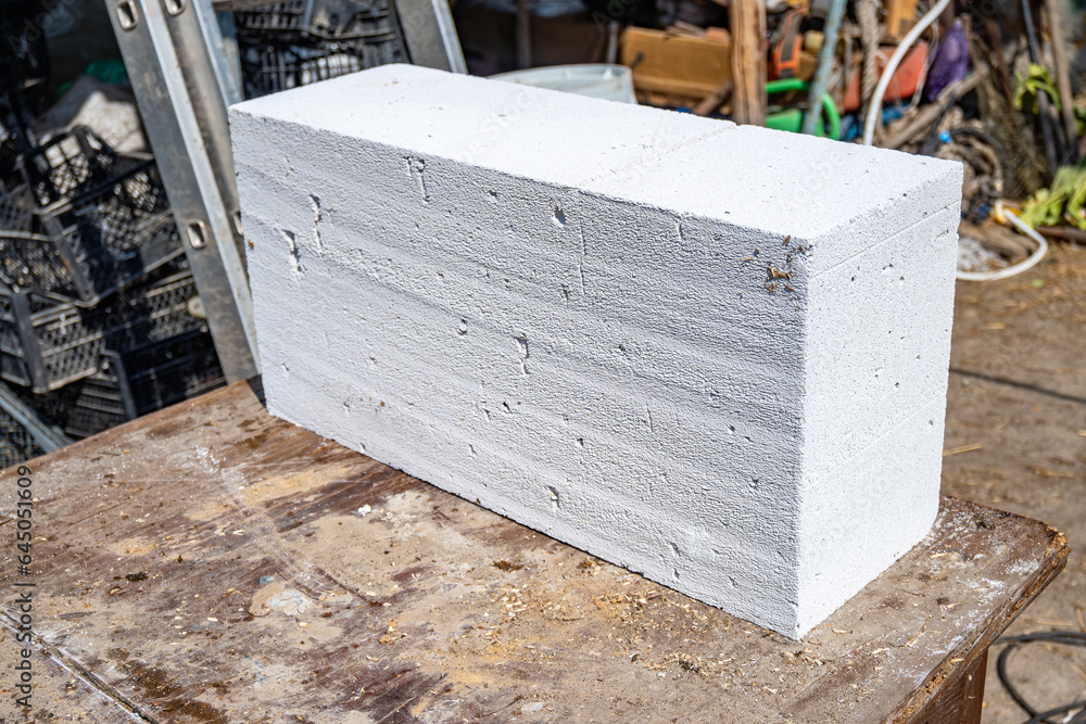 White aerated concrete block, brick closeup. Laying aerated concrete blocks. Construction of
