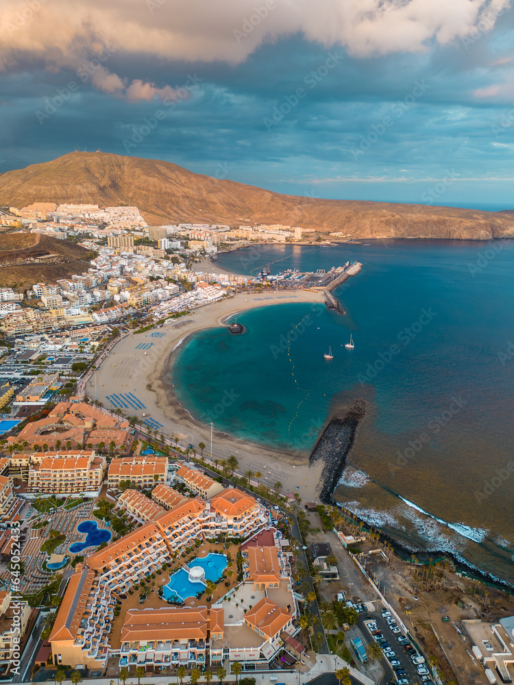 sunset at ocean shore with hotels and villas of Tenerife, Canary island, aerial