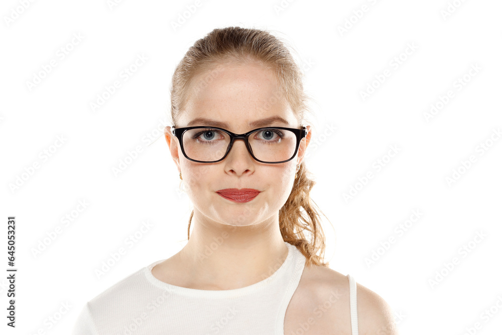Portrait of young blonde woman with glasses and impatient face gesture on a white background Portrait of young blonde woman with glasses and impatient face gesture on a white background