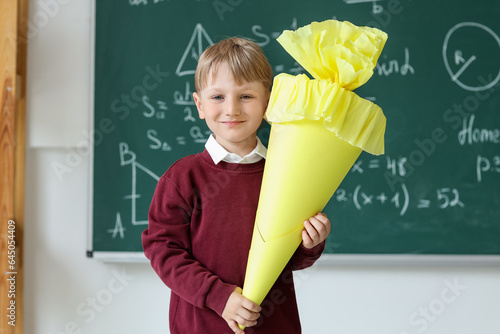 Happy little boy with yello...