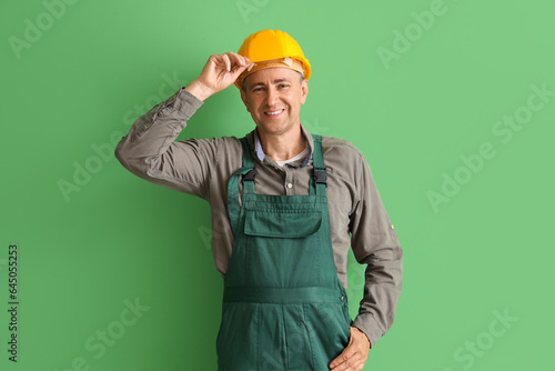 Mature builder on green bac...