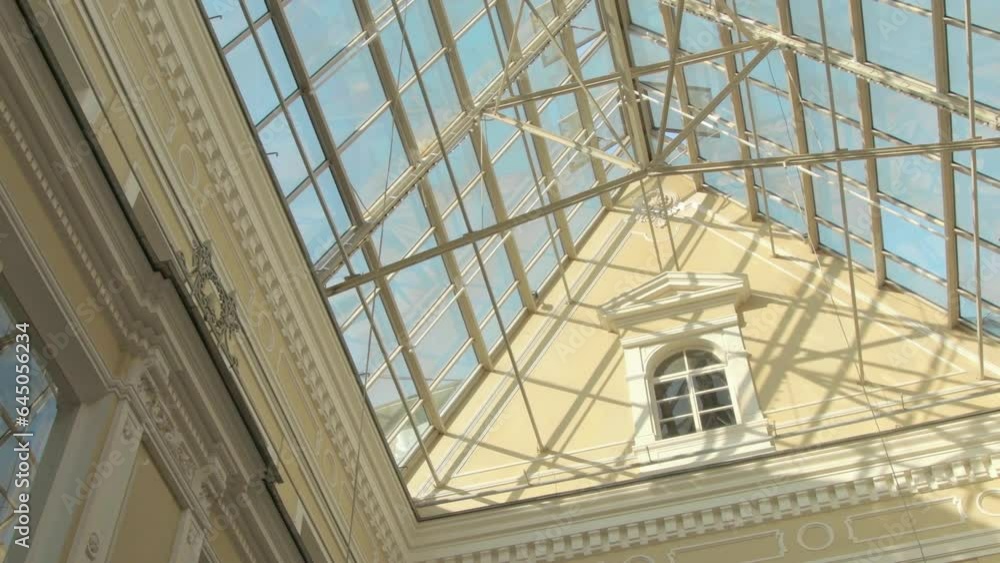 beautiful glass ceiling of old style Europian shopping mall with blue sky through. old Europian building in new-greek style in St, Petersburg beautiful glass ceiling of old style Europian shopping mall with blue sky through. old Europian building in new-greek style in St, Petersburg