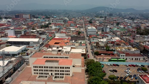 vuelo con drone sobre la ciudad de Guatemala Zona centro con casas y edificios horizonte techos y azoteas con montañas y cerros al fondo calles y caminos photo