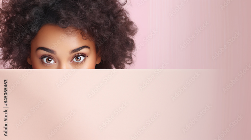 text space for advertising with funny part as portrait of afro american female model peeking over a colored panal