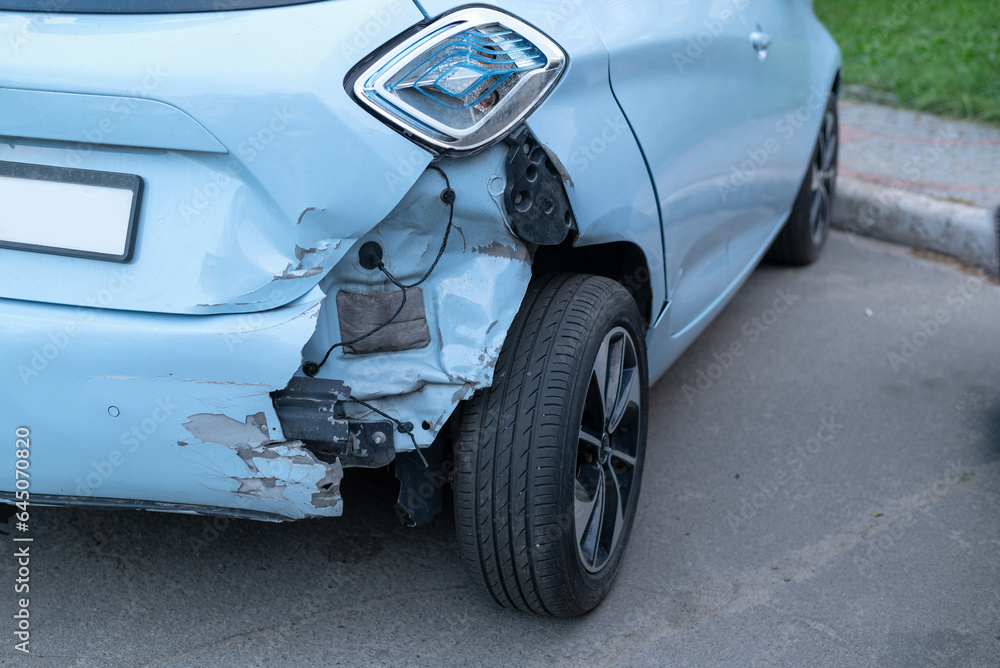 Back side of blue color car big damaged and broken by accident on road. dented back hatch