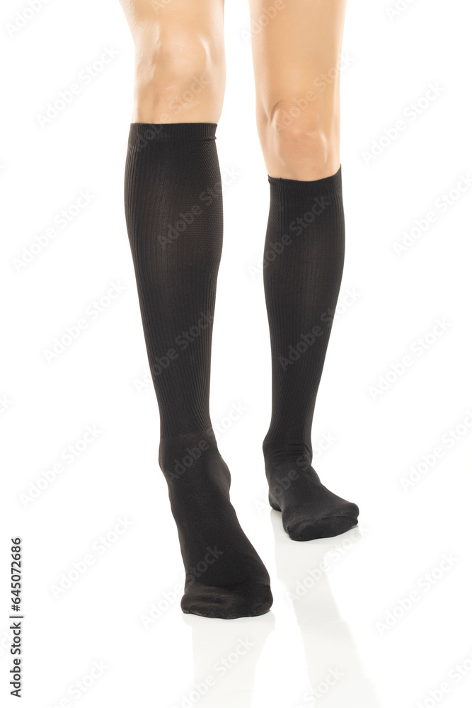 Female legs in compression Hosiery. Medical stockings, tights, socks, calves and sleeves for varicose veins and venouse therapy. Clinical knits. Sock for sports isolated on white background Female legs in compression Hosiery. Medical stockings, tights, socks, calves and sleeves for varicose veins and venouse therapy. Clinical knits. Sock for sports isolated on white background