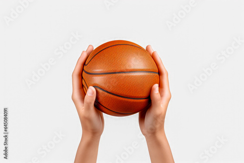 Cropped image of two female hands holding basketball ball on white background © mila103