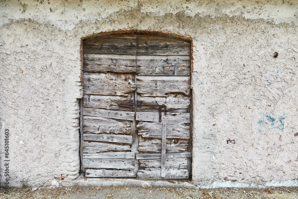 Old stable door with beautiful grain on a farmhouse in Tuscany, Italy. Detail. Old stable door with beautiful grain on a farmhouse in Tuscany, Italy. Detail.