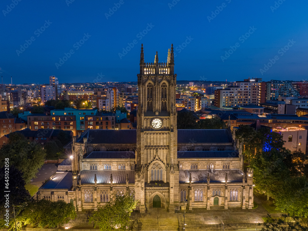Naklejka premium Leeds Minster, City Centre church in Leeds, Yorkshire. Aerial view of the large church at night. Christian place of worship in northern england