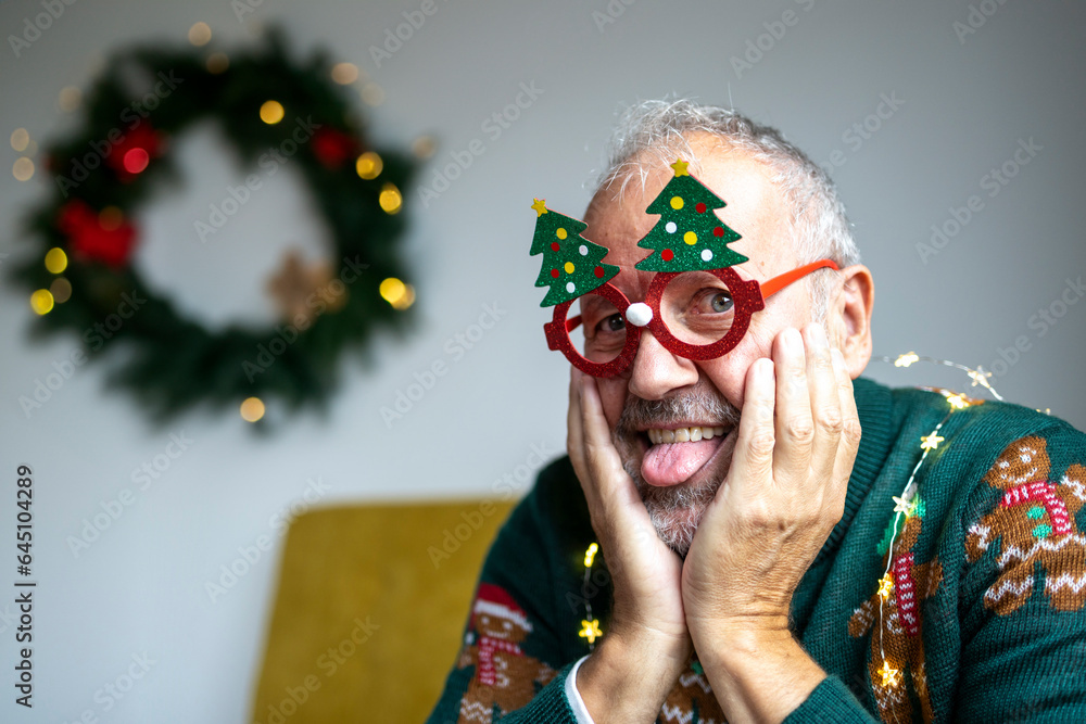 Portrait of a mature man with funny Christmas glasses Portrait of a mature man with funny Christmas glasses