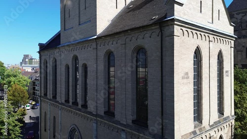 Drone flight along the Basilica of St. Kunibert in Cologne, Germany, in 4k on a bright hot summer day in September 2023 photo