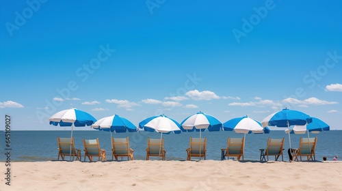 Summer beach deck chairs and protective umbrellas on the seashore