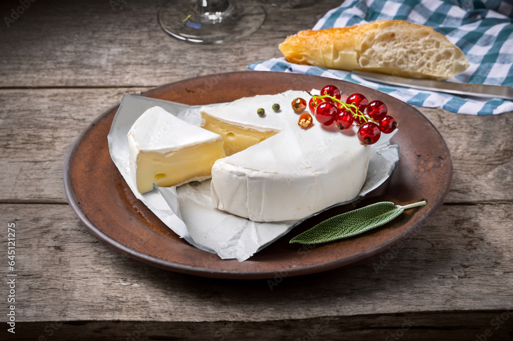 Rustic still life with sliced camembert berries and baguette Rustic still life with sliced camembert berries and baguette