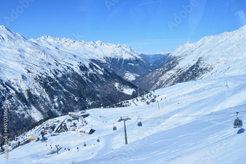 Gondola ski lifts in Hochgurgl ski resort, backdropped by the Otztal valley and the snow capped alpine mountains in Tyrol, Austria. © Elenitsa