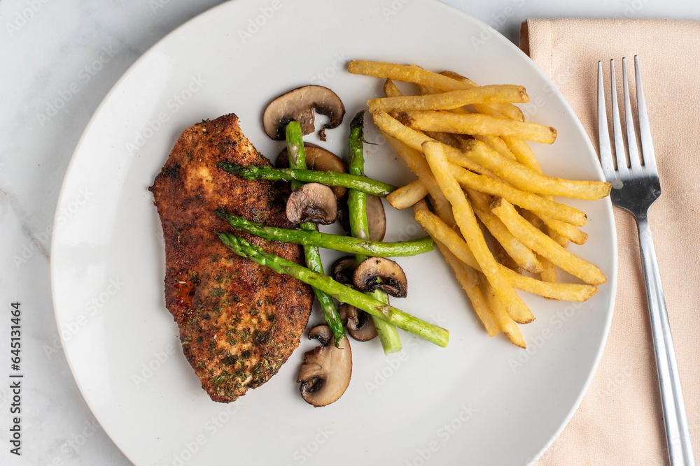 season chicken breast with sauteed  vegetables and fries