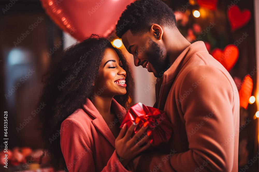 Beautiful african american young couple looking in love, concept of valentines day gift
