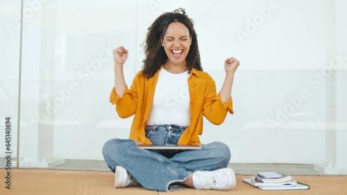 Success, win. Joyful curly haired brazilian or hispanic female student, sits on the floor near the university campus, finished studying online, rejoicing in luck, gesturing with both hands, smiling