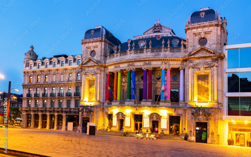 Illuminated opera house in Antwerp at dusk. Antwerpen opera building decorated with LGBT flags and multicolored columns.