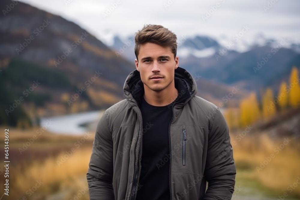 Handsome young man on the background of mountains